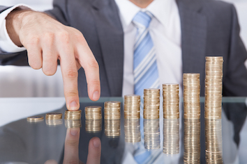 Man with piles of coins